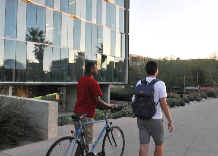 uarizona students walking with bike