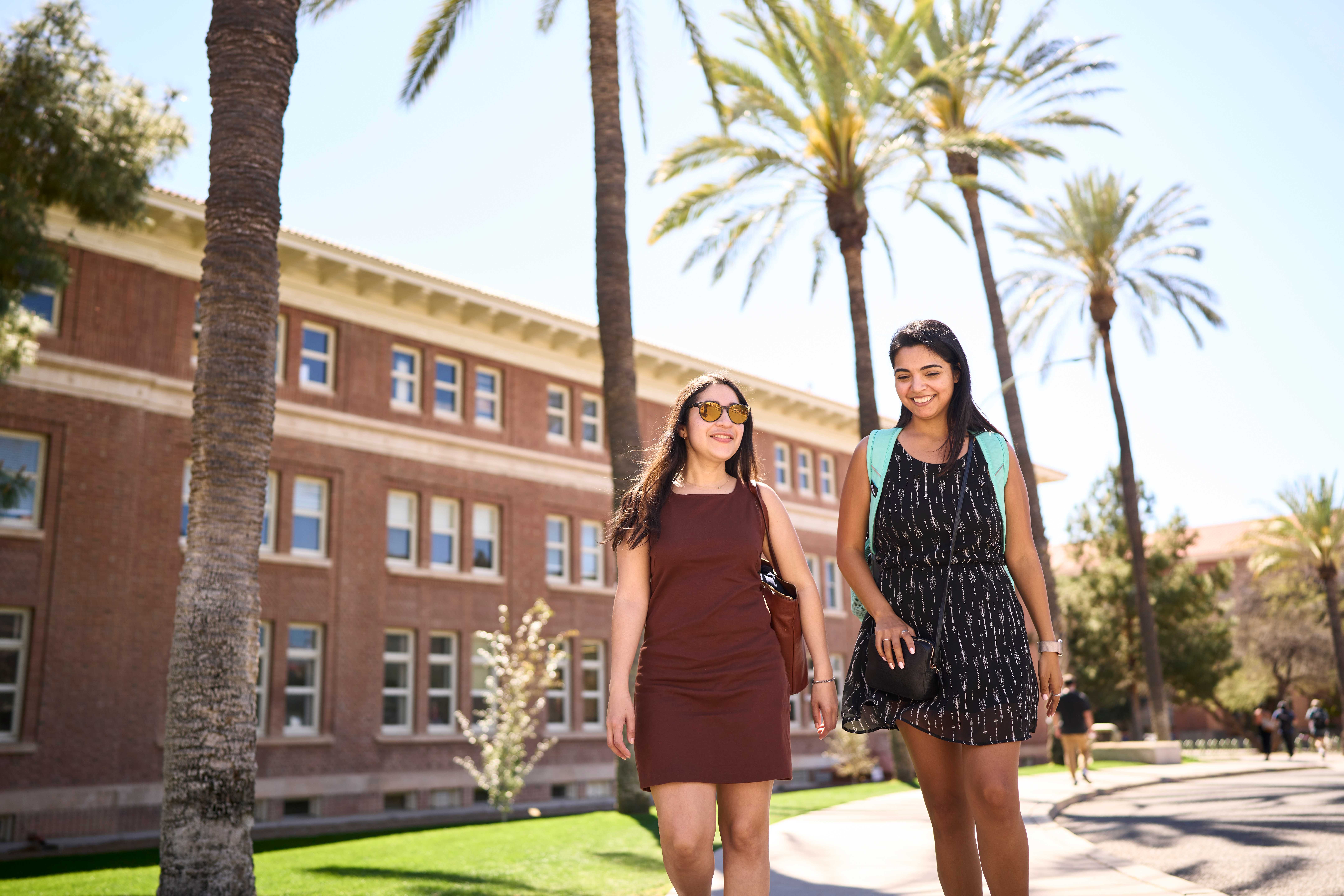 Two women walking on the University of Arizona campus. 