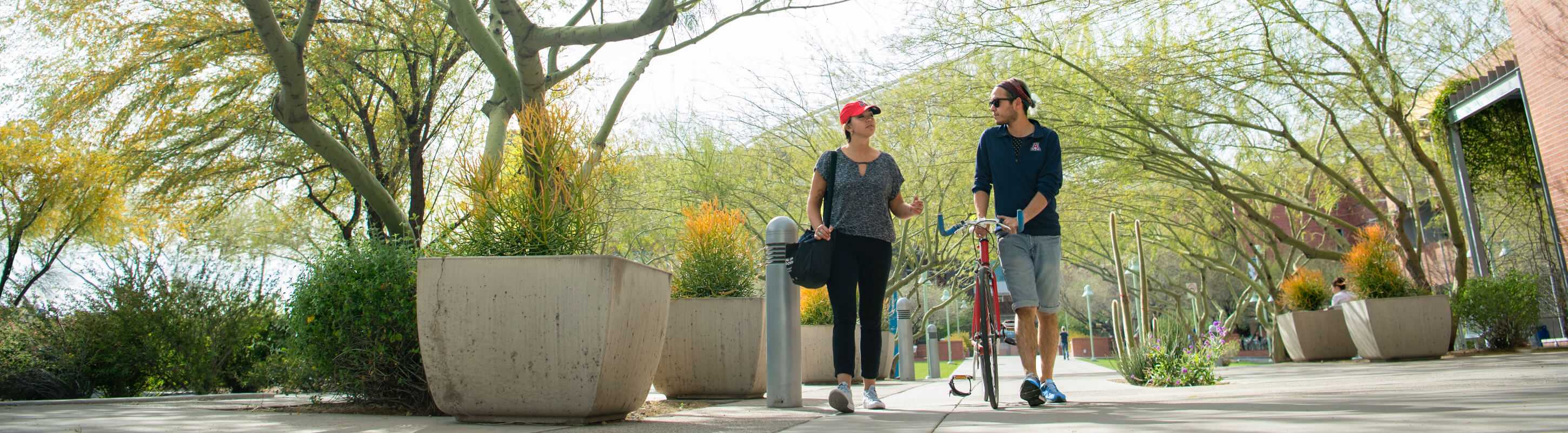 two students walking on the bike path on the UArizona campus