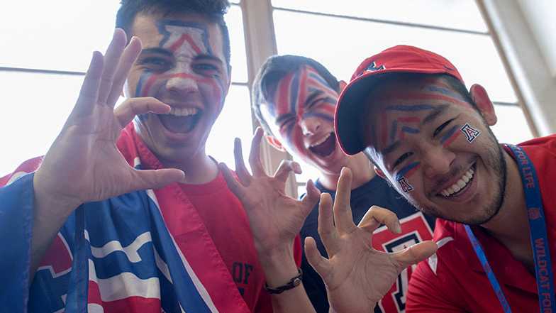 Students displaying the Wildcat claw sign