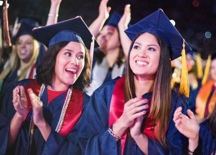 Two students celebrating at graduation