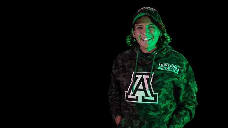 Image of student Kathy Nunez smiling in front of dark background