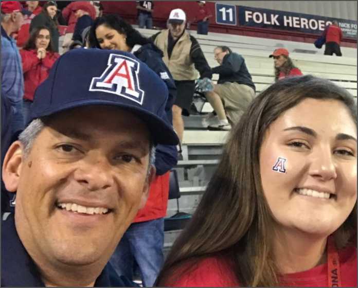 UArizona student and dad showing their pride at football game