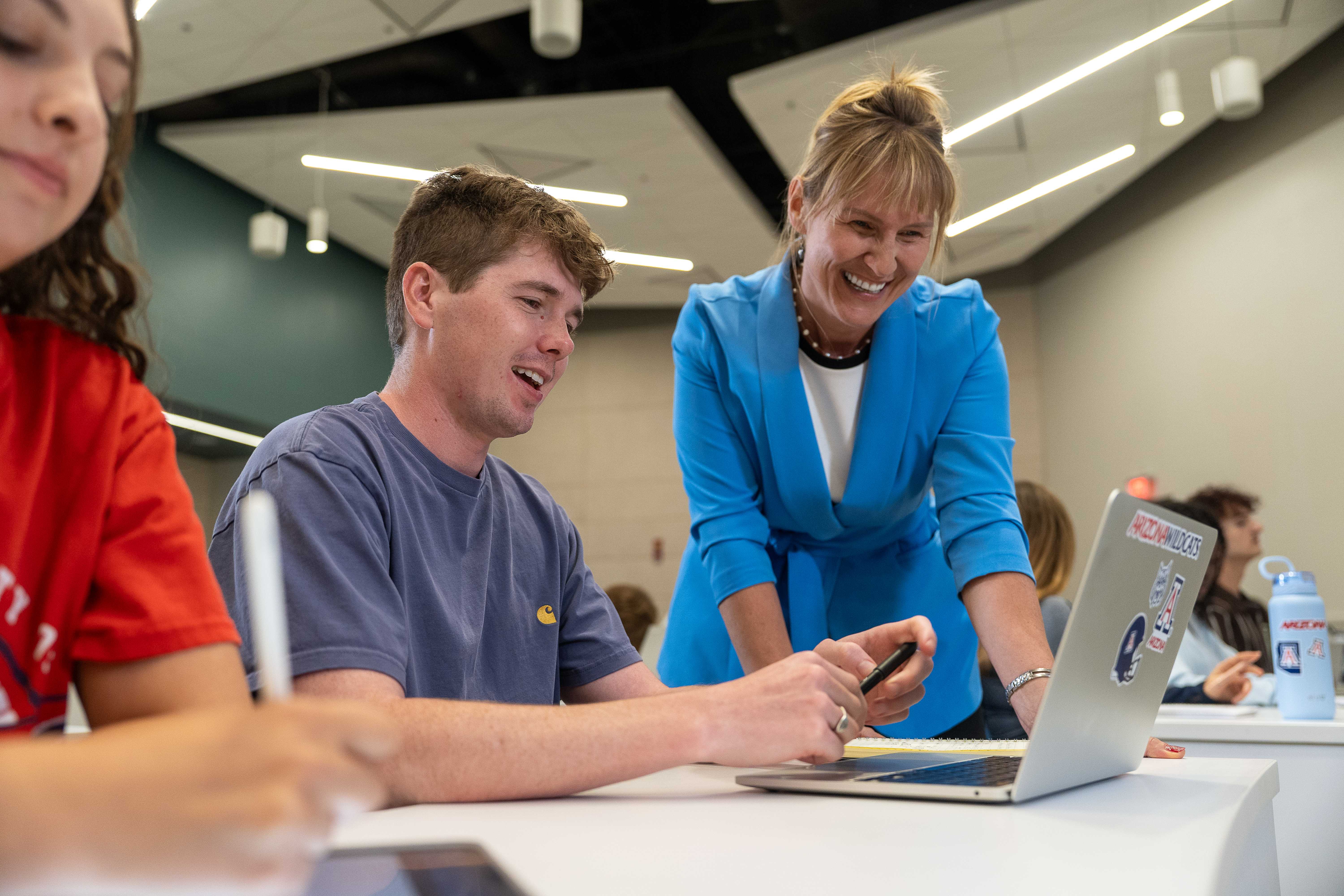 A photo of a professor helping a student. 