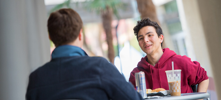 Students sitting outside enjoying coffee at University of Arizona Student Union Bookstore.