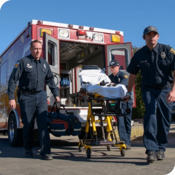firefighters moving someone from the ambulance