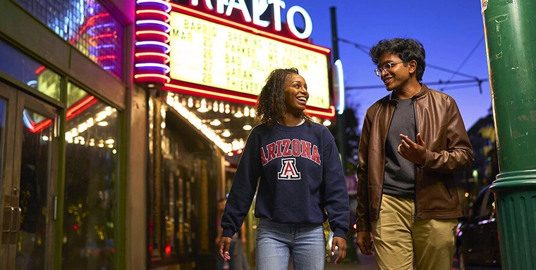 Students walking past the Rialto Theater in Downtown Tucson