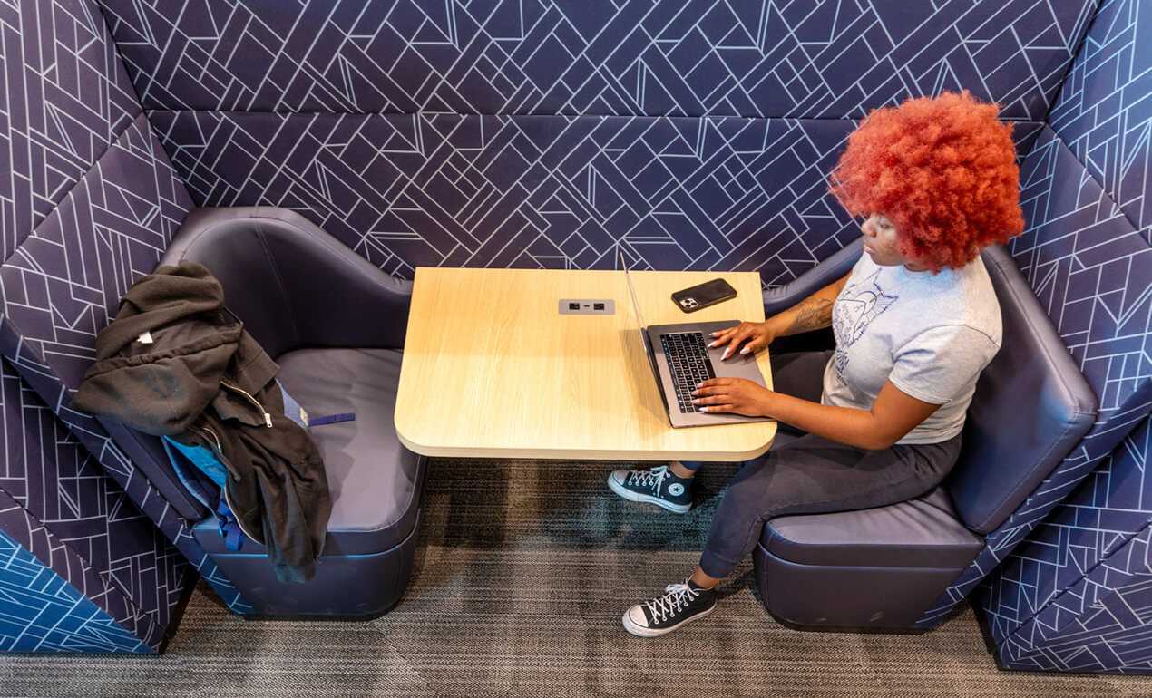 student working on homework in a study corner