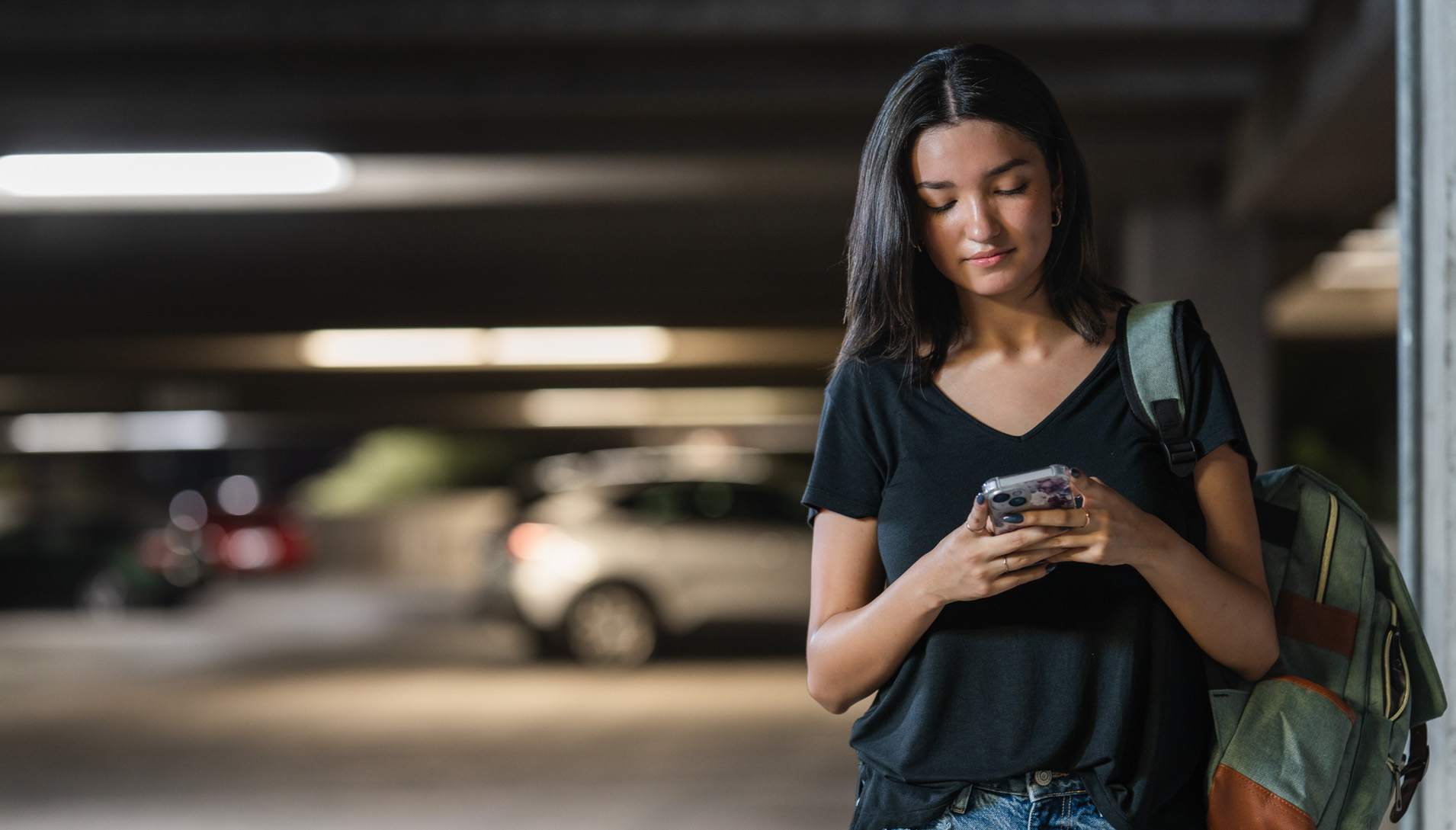 woman on her phone in the parking garage