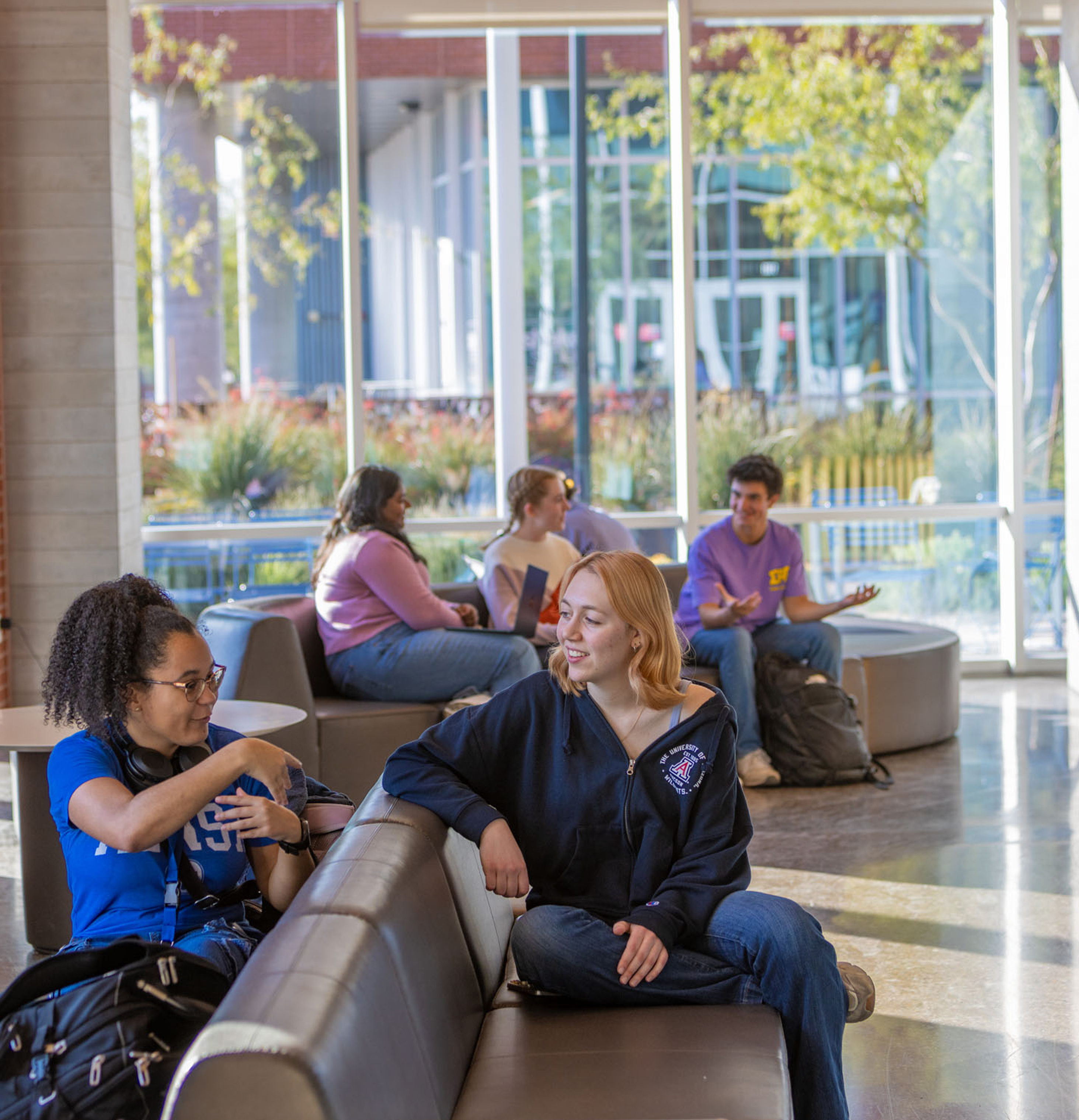 group of students talking in a waiting area