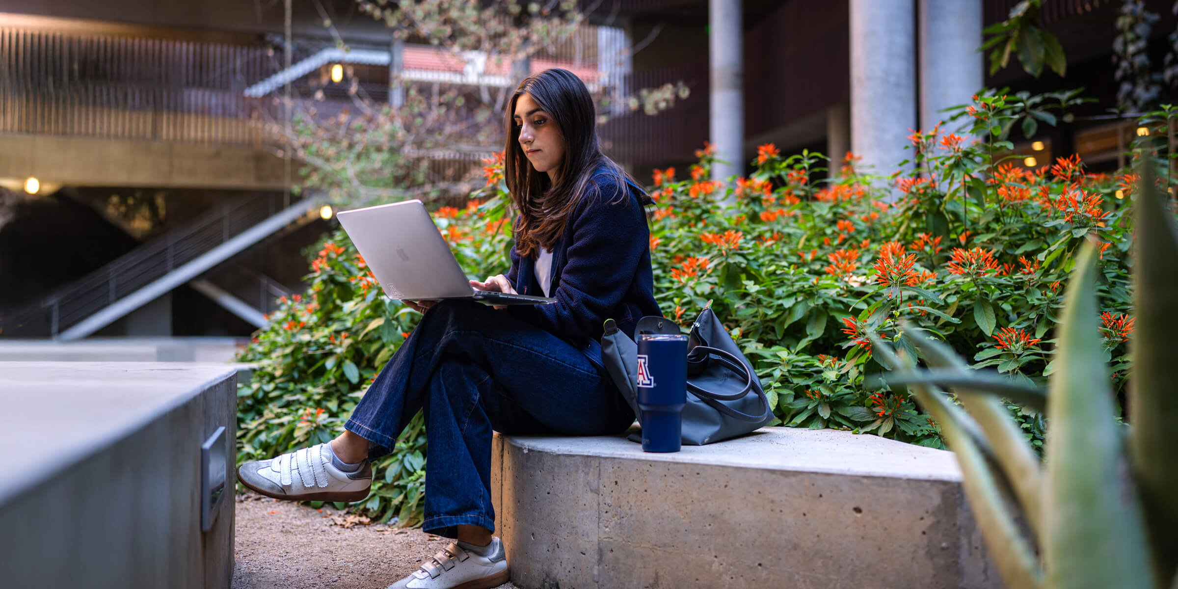 woman studying outside on campus