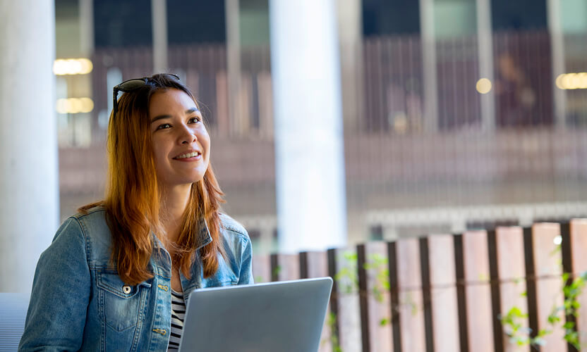 student studying outside on campus