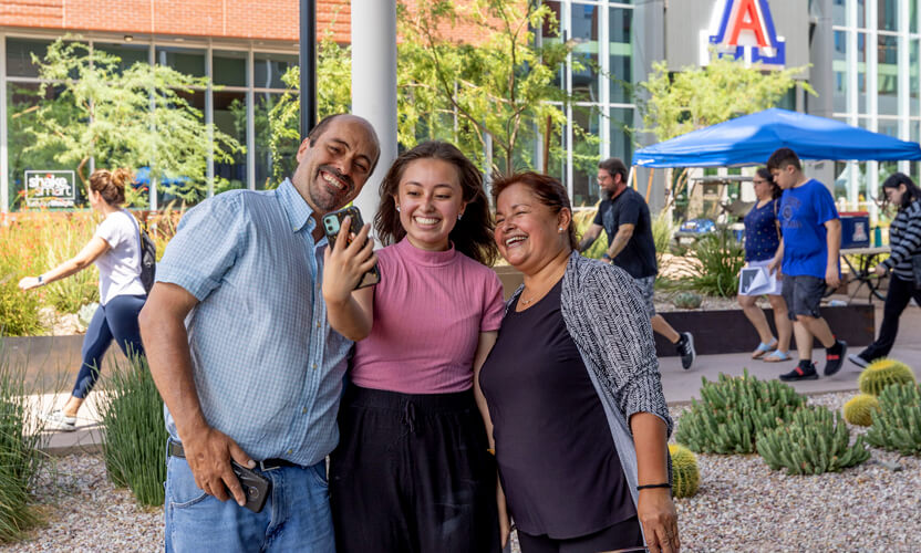 student with her parents
