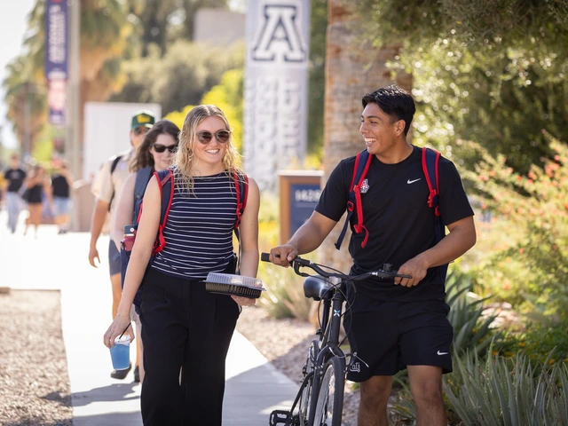 A group of students walk down the University of Arizona mall.