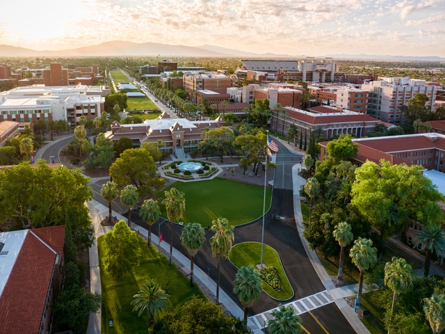 an aerial photo of campus at sunrise with old main as the focal point