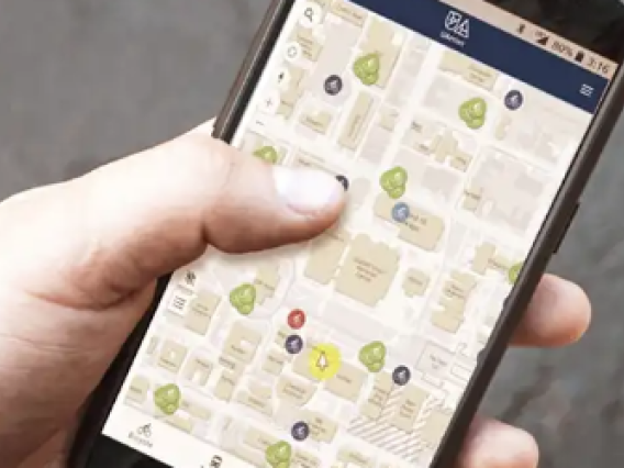 Arizona student holding a phone navigating an interactive map