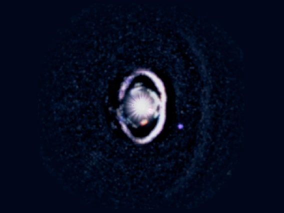 The star, WISPIT 2, appears a bright spot in the center, surrounded by a white, bright ring of dust. Two small dots indicate the growing protoplanets in the system. 