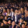 graduates standing in a crowd at commencement