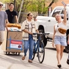 a group of people walking with their belongings into a building